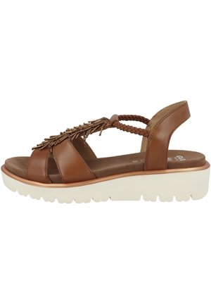 Brown leather sandal with braided accents and decorative metallic embellishments. Features a cushioned, white platform sole.
