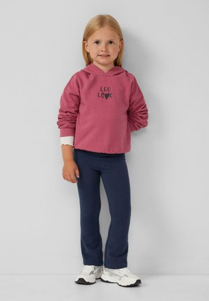 Rosa Kapuzenpullover mit "LEO LOVE" Grafik, cremfarbene Bündchen, kombiniert mit marineblauen Hose und weißen Sneakern. Glatte Textur, lässiger Stil, entspannte Passform.