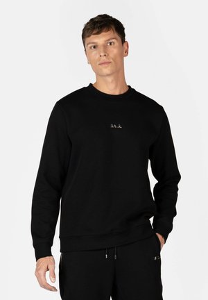 Svart sweatshirt med rund hals, långa ärmar och en minimalistisk broderad logotyp på bröstet. Mjuk tyg med ribbad mudd.