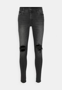 Jeans skinny pretos em denim, apresentando rasgos desgastados nos joelhos e um design clássico de cinco bolsos. Textura suave e formato ajustado.