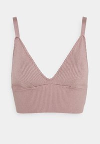 Ljusrosa ribbad bralette med v-ringning och justerbara axelband. Har en texturerad yta och en sömlös design.