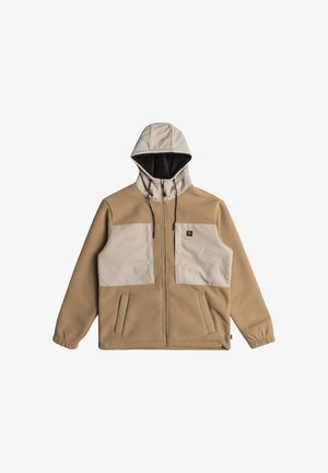 Beige jas met capuchon, voorzien van twee grote beige voorzakken, een rits aan de voorkant en een gestructureerde stof. Binnenvoering van donker materiaal.