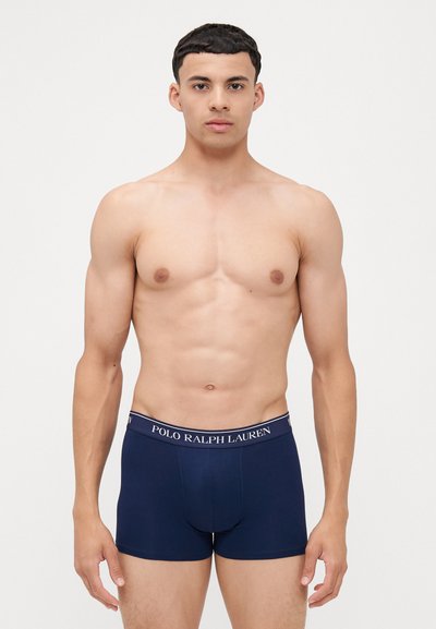 Sötétkék pamut stretch alsónadrág elasztikus derékpánttal, rajta a "POLO RALPH LAUREN" logóval. Testhez álló fazon, sima textúra, mintázat nélkül.