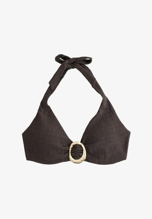 Close-up of a person wearing a textured dark brown bikini top with a large circular gold clasp at the center.