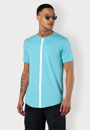 Light blue short-sleeve t-shirt made of soft fabric, featuring a white vertical stripe and the word "ESTEEM" printed in a slim font.