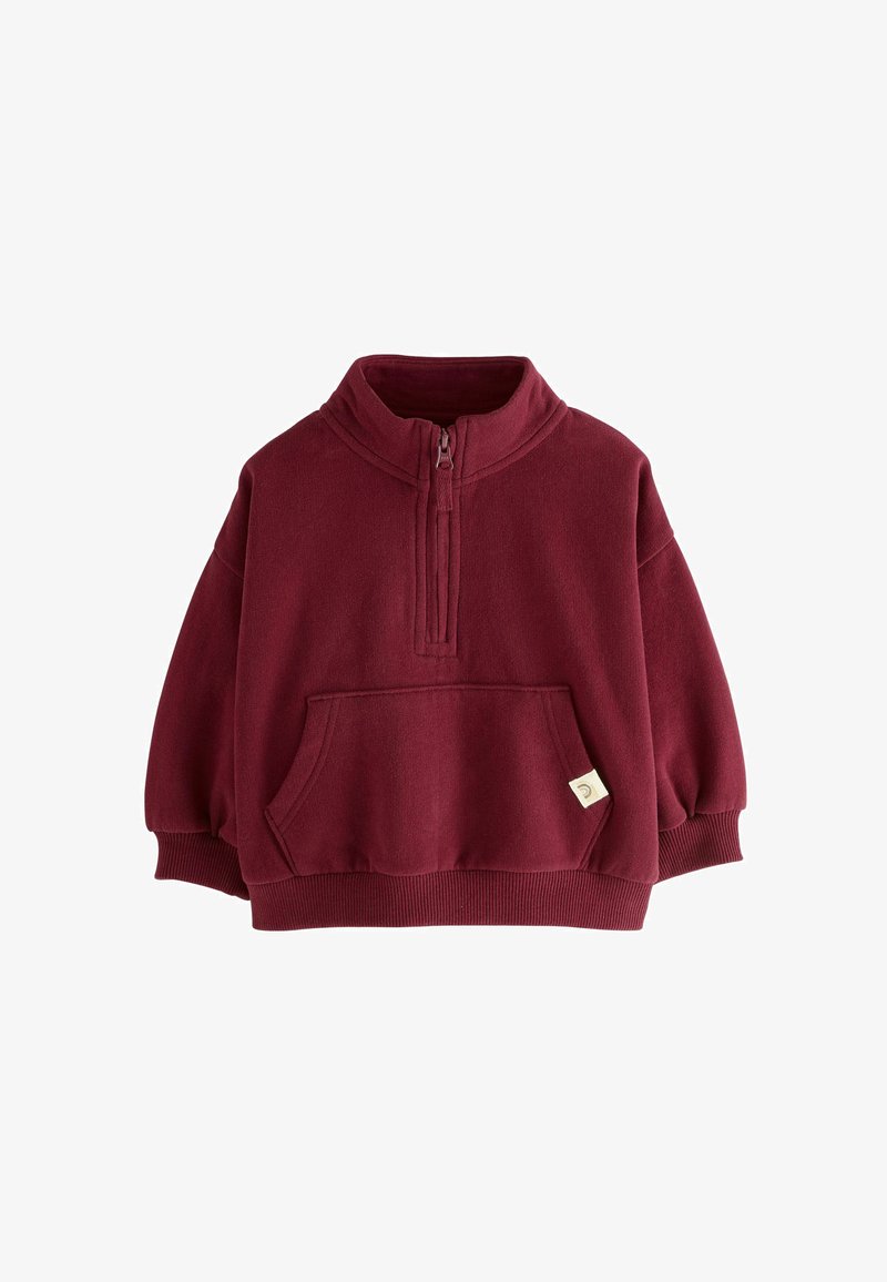 Pull en polaire bordeaux avec demi-zip, poignets côtelés, poche avant et petite étiquette. Texture douce et coupe décontractée. Idéal pour un usage quotidien.