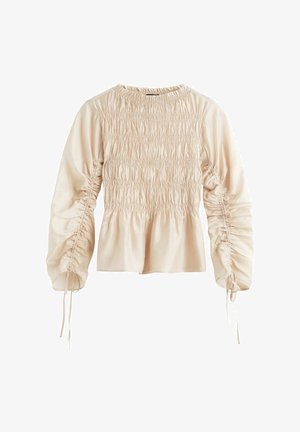Flødefarvet bluse med lange ærmer og rynkede detaljer foran og på ærmerne, med snørebind ved ærmekanterne.