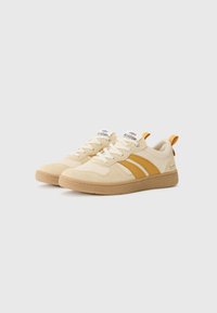 Beige sneakers with suede upper, caramel stripes, round toe, and textured rubber sole. Features white laces and heel loop for easy wear.