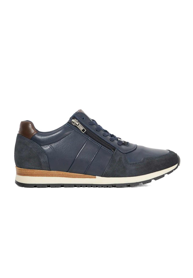 Navy leather and suede sneaker with a textured finish, featuring a side zip, fabric laces, and a contrasting tan heel accent. Rubber sole.