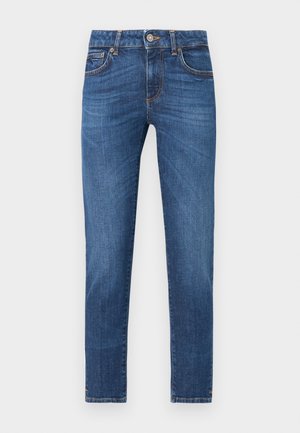 Jean en denim bleu coupe slim avec cinq poches, fermeture par bouton et zip, et détails légèrement délavés sur le devant des cuisses.