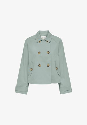 Kahekordse rinnaga erkroheline jakk kergest kangast, millel on suured pruunid nööbid, küljetaskud ja struktureeritud krae rullitud varrukate manustega.