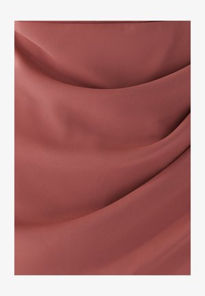 Soft, ruched fabric in dusty rose color with smooth folds and a slight sheen, highlighting the texture and drape of the material.