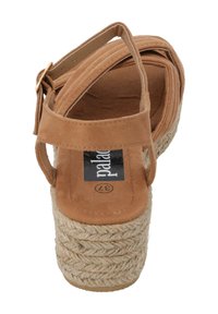Brown suede women's platform sandals with ankle strap and woven jute heel. Features a padded insole and a smooth, flat sole.