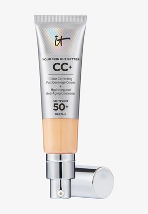 Tube pompe argenté et beige de crème CC+ d'IT Cosmetics avec SPF 50+ et correcteur anti-âge, bouchon placé à côté.
