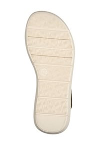 Schoenenzool in lichtbeige rubber met een gestructureerd oppervlak, voorzien van horizontale groeven en een cirkelvormig logo nabij de hak.