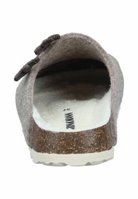 Back view of a brown felt slip-on clog with a cork sole and white fuzzy interior lining.