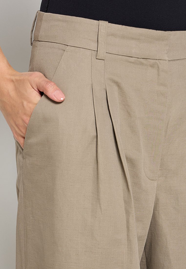 Beige broek van een zachte, gestructureerde stof met voorplooien en zijzakken, met een aansluitend ontwerp van de tailleband.