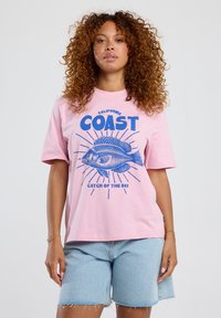 Pink cotton t-shirt with blue graphic of a fish, text "California Coast" and "Catch of the Day," short sleeves, relaxed fit.