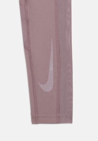 Leggings de sport bordeaux avec des panneaux en mesh, arborant un logo Nike blanc avec un motif à rayures diagonales. Texture de tissu lisse et coupe ajustée.