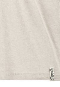 Light gray short-sleeve shirt with a smooth texture. Features a sewn-in label at the hem with "SUBLEVEL my favourites" in black text.