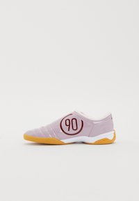 Purple athletic shoe with yellow sole, smooth texture, lateral 90 emblem, and diagonal stitching details. Low-profile, slip-on design.