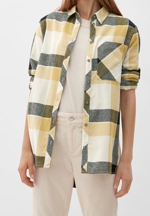 Camicia button-up a maniche lunghe con un motivo a quadri gialli, grigi e neri. Realizzata in un tessuto dalla consistenza morbida, con una tasca sul petto.