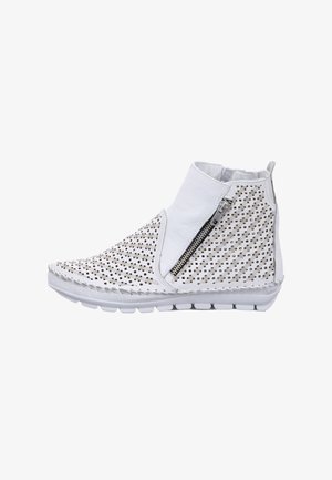 White ankle boots with perforated design, side zipper, textured material, and flexible sole. Features decorative stitching along the edges.