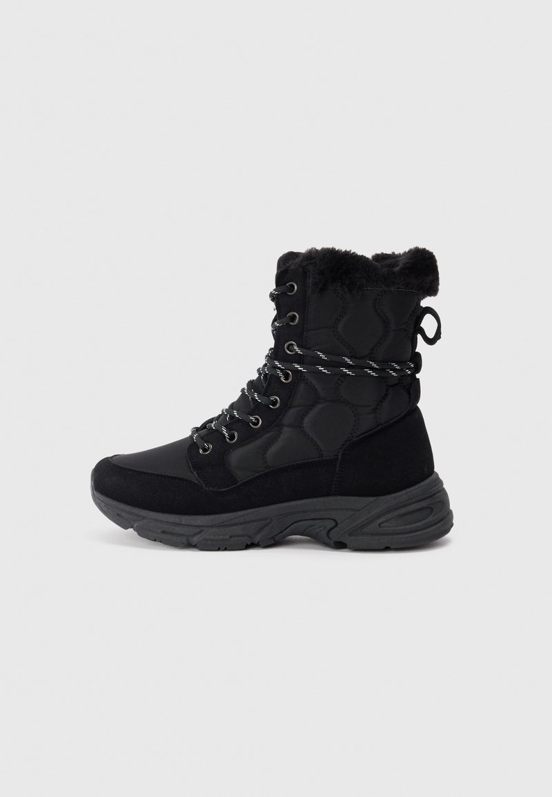 Black high-top winter boot with quilted fabric, faux fur lining, lace-up front, and thick rubber sole on white background.