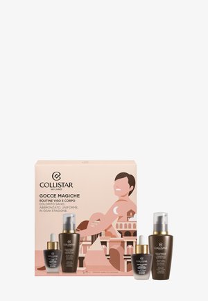 Collistar Gocce Magiche-setet i en ljusrosa låda innehåller tre bruna glasflaskor med gulddetaljer, som innehåller hudvårdsprodukter.