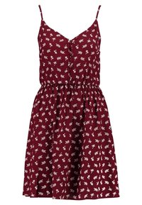 Burgundy ärmlös klänning med åtsittande midja, knäppning framtill och vitt blommönster; lätt tyg med en slät textur.