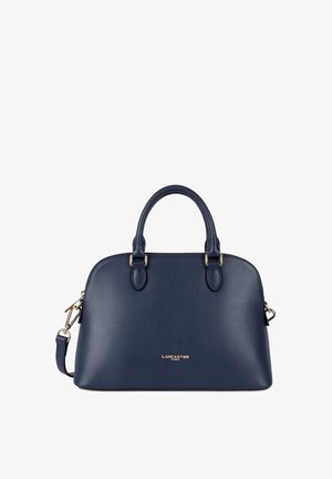 Sac à main en cuir bleu marine avec des accessoires dorés, forme structurée, doubles poignées supérieures et une bandoulière amovible. Présente un logo sur le devant.