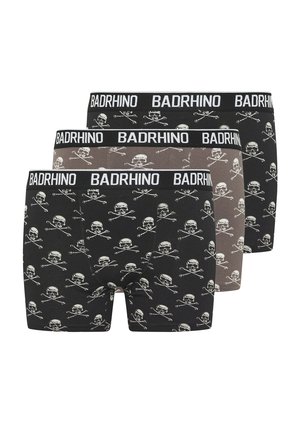 Tres bóxers para hombre en negro y gris con patrones blancos de calaveras y huesos cruzados, y cinturillas con la marca "BADRHINO".