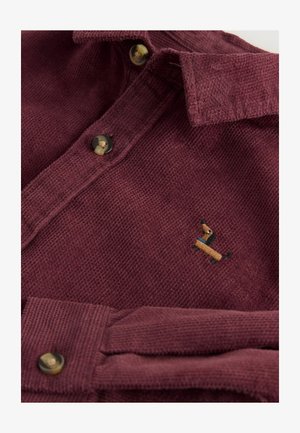 Cămașă din corduroy burgundy cu guler butonat, având un mic design brodat cu un teckel și nasturi în contrast.
