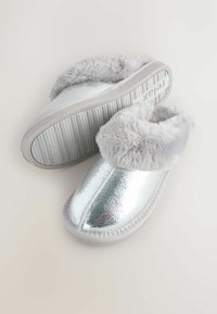 Silver faux leather slippers with a fluffy gray fur trim, round toe, and a textured sole featuring vertical grooves for grip.