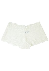 Boyshorts bianchi in pizzo con motivo floreale, bordi scallopati e una decorazione a fiocco centrale in vita. Tessuto morbido e di consistenza.