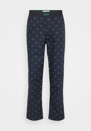 Mørkeblå pysjamasbukser med grønn krokodillemønster. Har elastisk liv med merkeflagg. Myk, lett stoff med en avslappet passform.