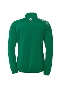 Grøn træningsjakke med lange ærmer, strukturerede detaljer på skuldrene og en høj krave. Har et logo på den bageste halsudskæring.