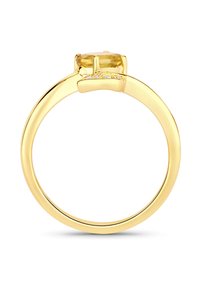 Bague en or avec une pierre précieuse jaune ovale, sertie dans un monture à quatre griffes. De petits accents clairs sur l'anneau rehaussent le design. Texture lisse.