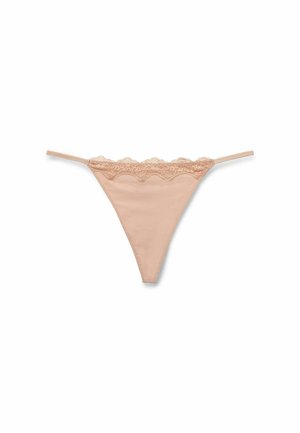 String nude en tissu lisse avec une dentelle florale le long de la taille, présentant un dos en V et des fines bretelles.