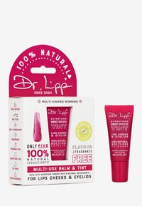Multi-use balm and tint in pink tube. Packaging highlights “100% Natural” and “Fragrance Free.” Features a hanging tab for display.