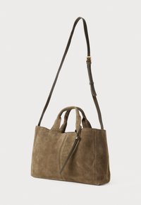 Brown suede handbag with short double handles and adjustable long shoulder strap with gold buckle, displayed against a white background.