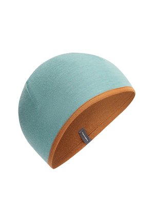 Berretto reversibile con tessuto esterno teal e fodera interna color ruggine, con piccolo etichetta nera del marchio sul bordo.