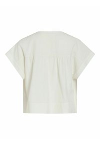 Blouse crème à manches courtes et coupe ample, avec un empiècement froncé sur le haut du dos et un ourlet large en bas.