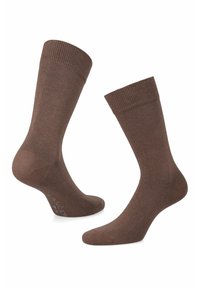 Brązowe skarpetki wykonane z gładkiego, teksturowanego materiału. Zaprojektowane z prążkowanymi mankietami i bezszwowym palcem dla wygody. Prosty, jednolity kolor.