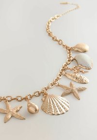 Next SHELL CHARM - Kaulakoru - gold tone