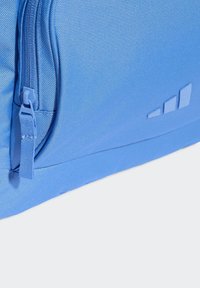 Blue backpack with a textured fabric, featuring a zipper closure, side pocket, and a logo with three ascending stripes.