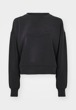 Czarna, krótka bluza z długim rękawem, okrągłym dekoltem i prążkowanymi mankietami. Wykonana z miękkiego materiału o gładkiej fakturze.