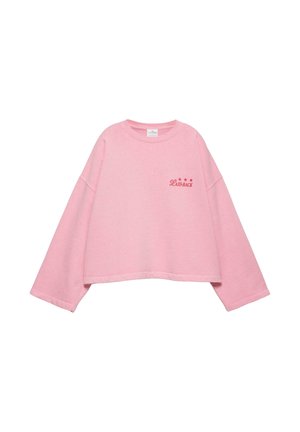 Világos rózsaszín rövidített pulóver széles ujjakkal, és piros "LAID-BACK" felirattal, három csillaggal a bal mellrészen.