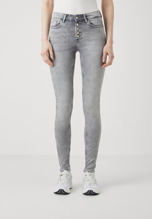 Skinny jeans in light gray denim, featuring a high waist and five-button fly closure. Smooth texture with subtle fading and no embellishments.