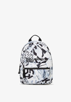 Rygsekk med et blankt svart og hvitt abstrakt mønster, med en frontlomme med glidelås, logo-tekst og et håndtak på toppen for bæring.